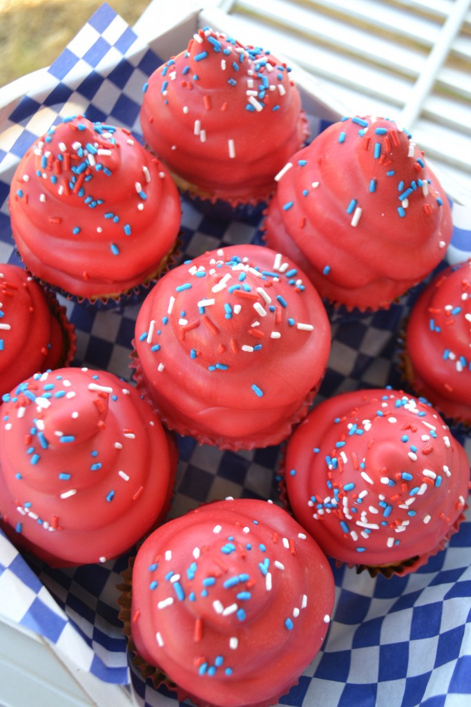 9 hi hat cupcakes topped with red candy melts and red white and blue sprinkles